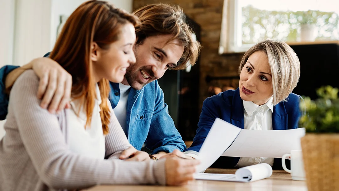 A couple speaks with a man and woman at a table, fostering an engaging dialogue