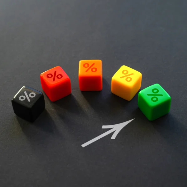 Four colored dice with an arrow pointing to the right, symbolizing a <b>good credit rating</b>.