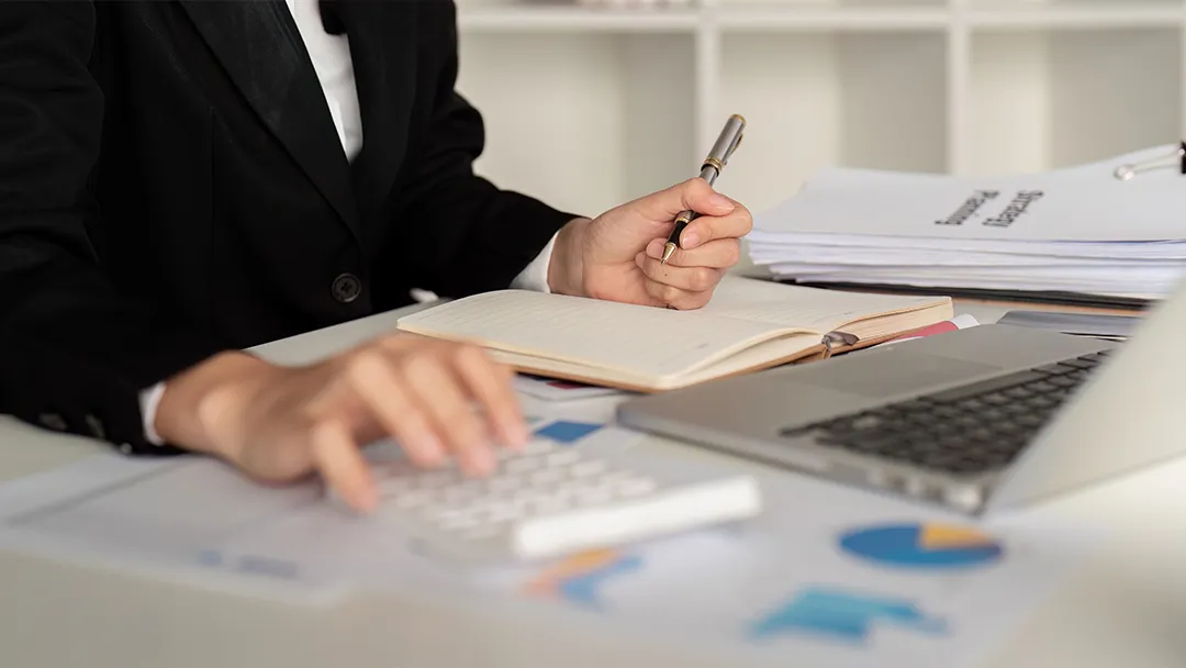 A person in a suit working on a laptop, focusing on fast online loans.