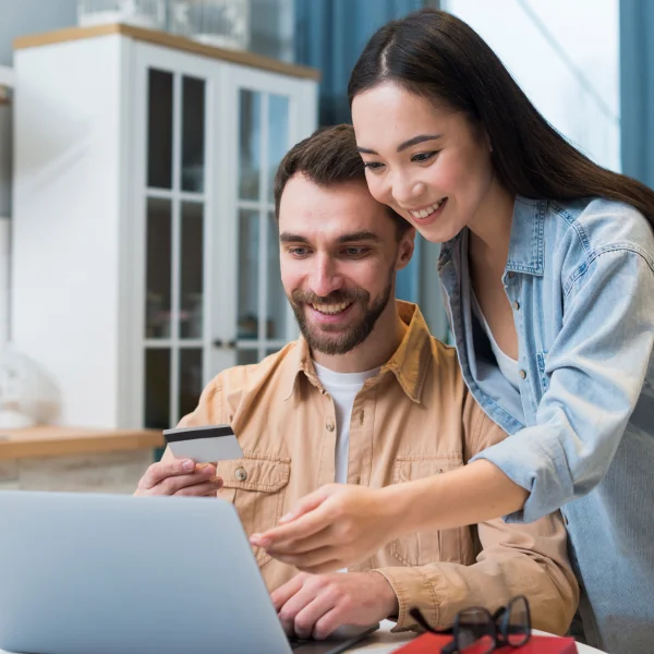 Un jeune couple utilise un ordinateur portable pour faire des achats en ligne, avec une option de livraison le jour même.